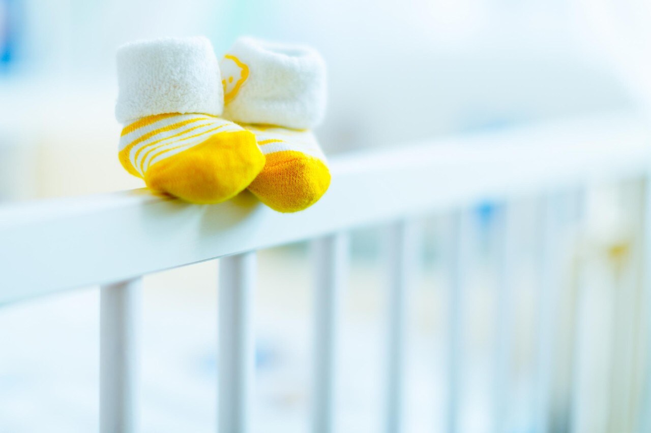 baby booties on a cot