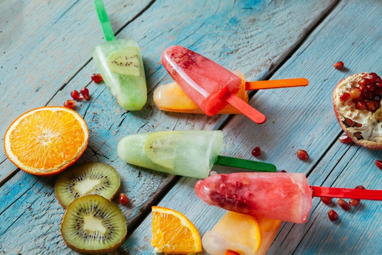 Colorful Homemade Popsicles With Orange, Kiwi And Pomegrante